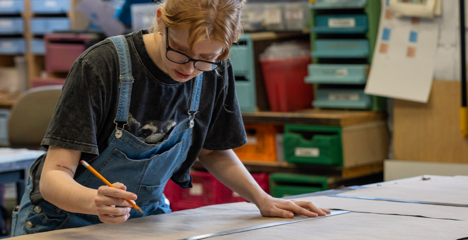 A student works at a drafting board