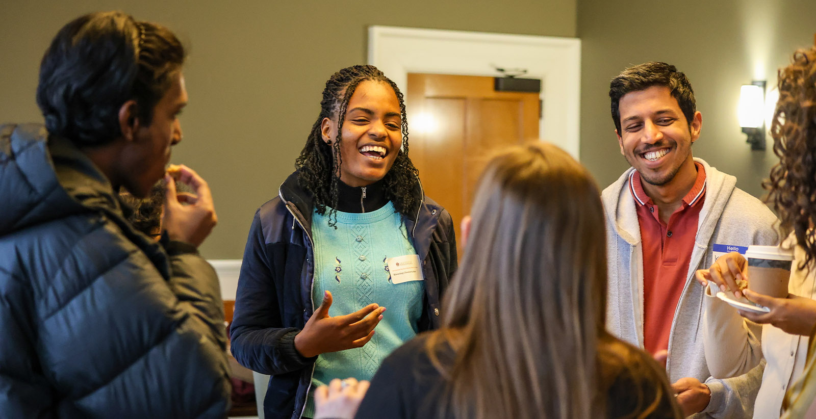 Students laugh and talk at an event