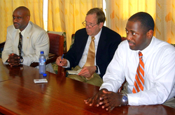 Charles Robinson, left, Bill Schwab and Calvin White discuss details of an exchange program before signing a memorandum of understanding with Cape Coast University in Ghana.