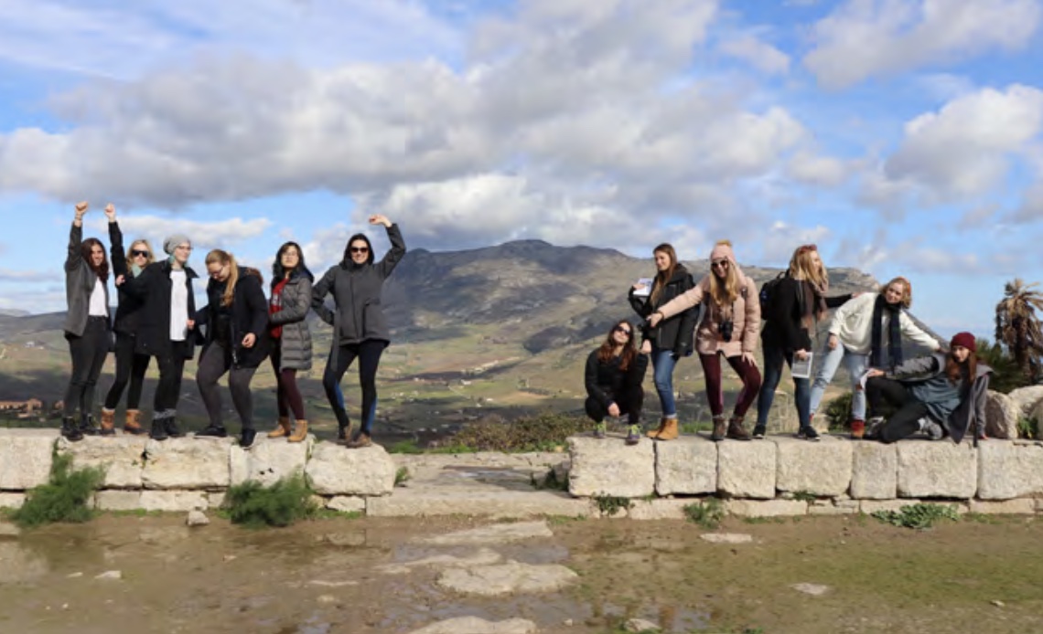 Dr. Vennarucci (sixth from the left) and students put on an act in the remains of the Greek theatre (late 4th/early 3rd c BCE) in Segesta, Sicily.